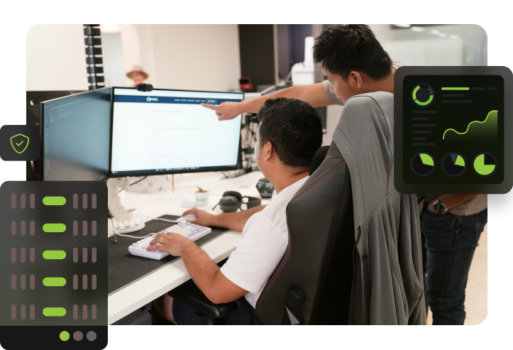 Two Click Click Media team members at a dual-monitor workstation reviewing server configuration, with a hosting rack icon, security shield, and performance monitoring dashboard overlaid.