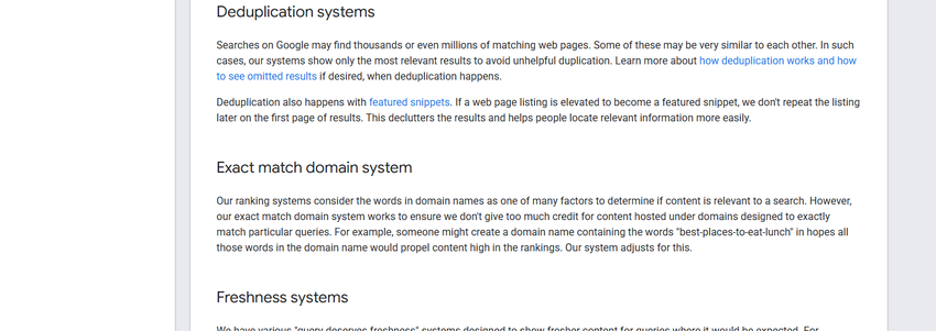 google's ranking-systems guide listing the exact match domain system among active systems, between deduplication and freshness systems.